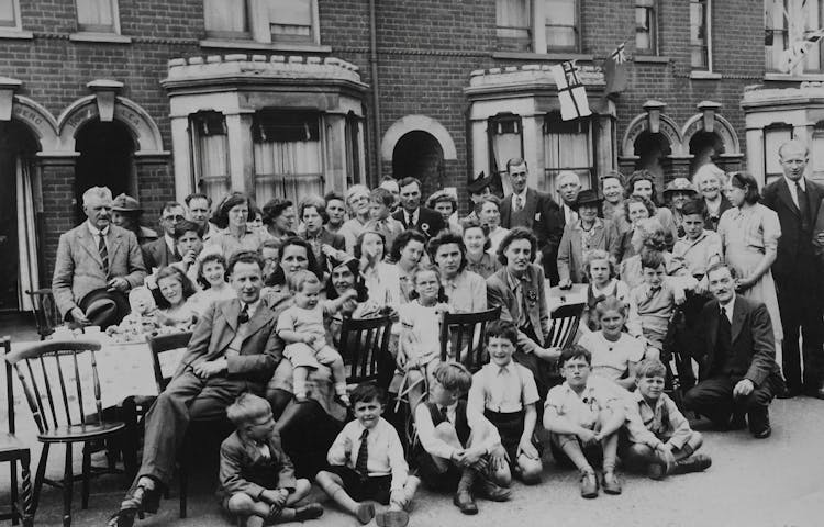 A Grayscale Photo Of People On The Street 