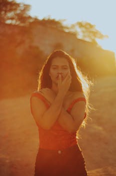 A young woman poses during a sunset photoshoot in Madre de Deus, Brazil, capturing the warm golden glow.