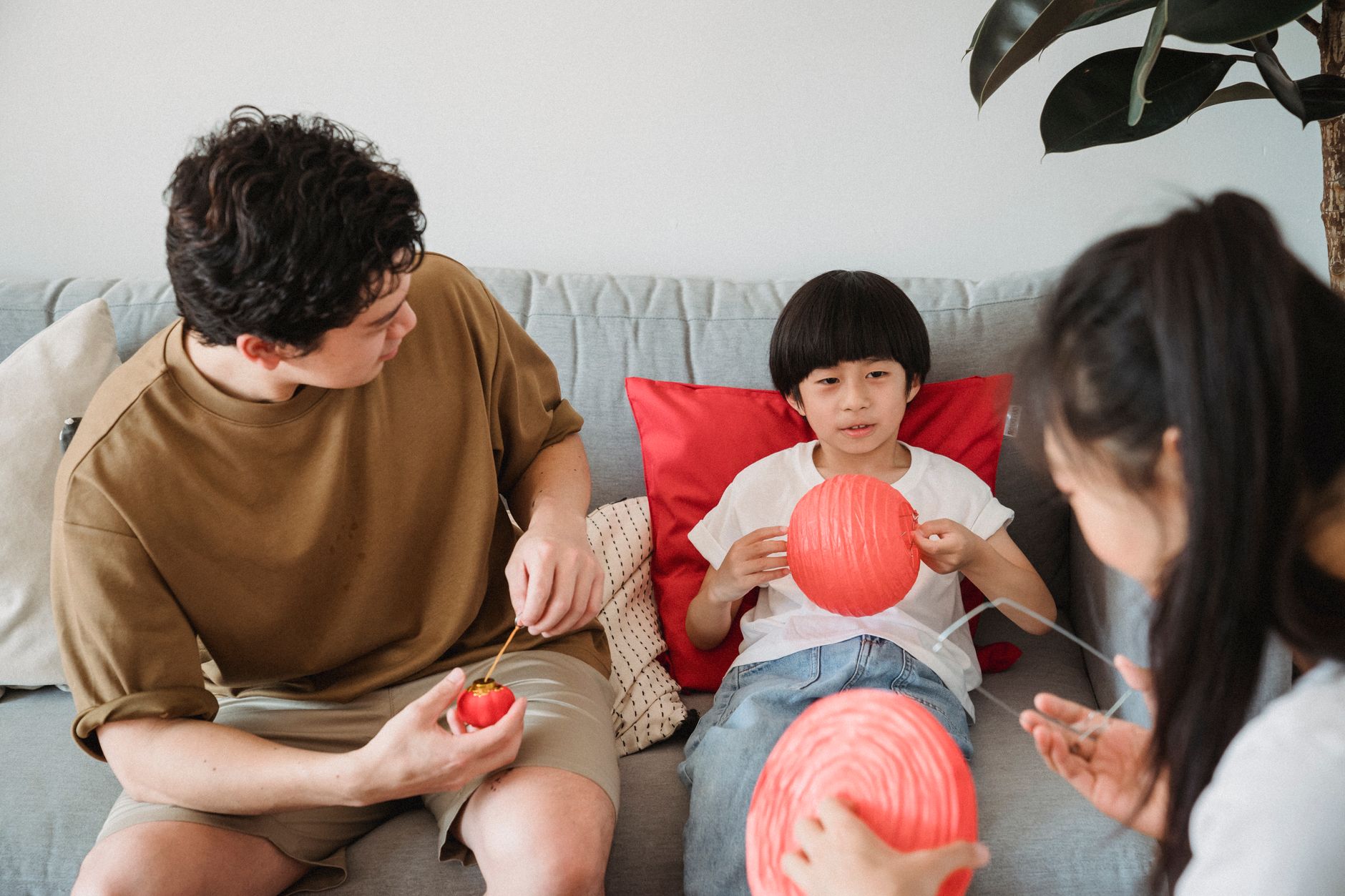 Cheerful family enjoying art and craft activities together indoors, fostering creativity and bonding.