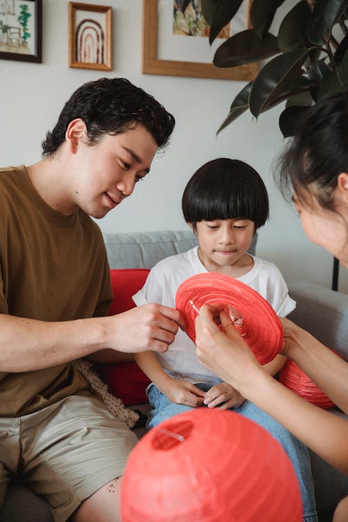 A Man Teaching His Son How to Make a Lantern