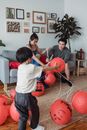 Family Fixing the Strings of Hanging Lanterns