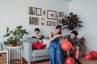 Family in the Living Room Fixing Hanging Lanterns