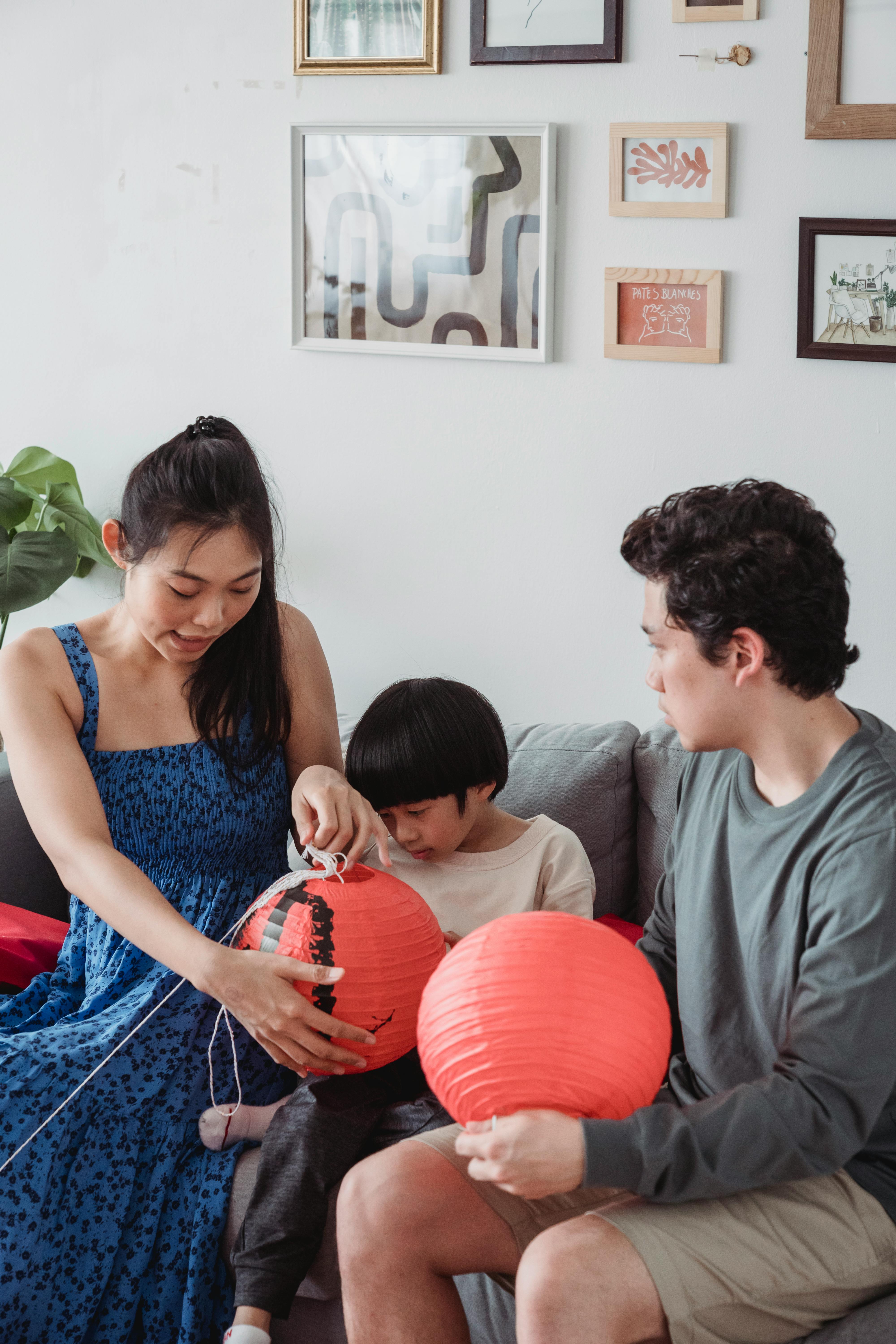 family fixing hanging lanterns together