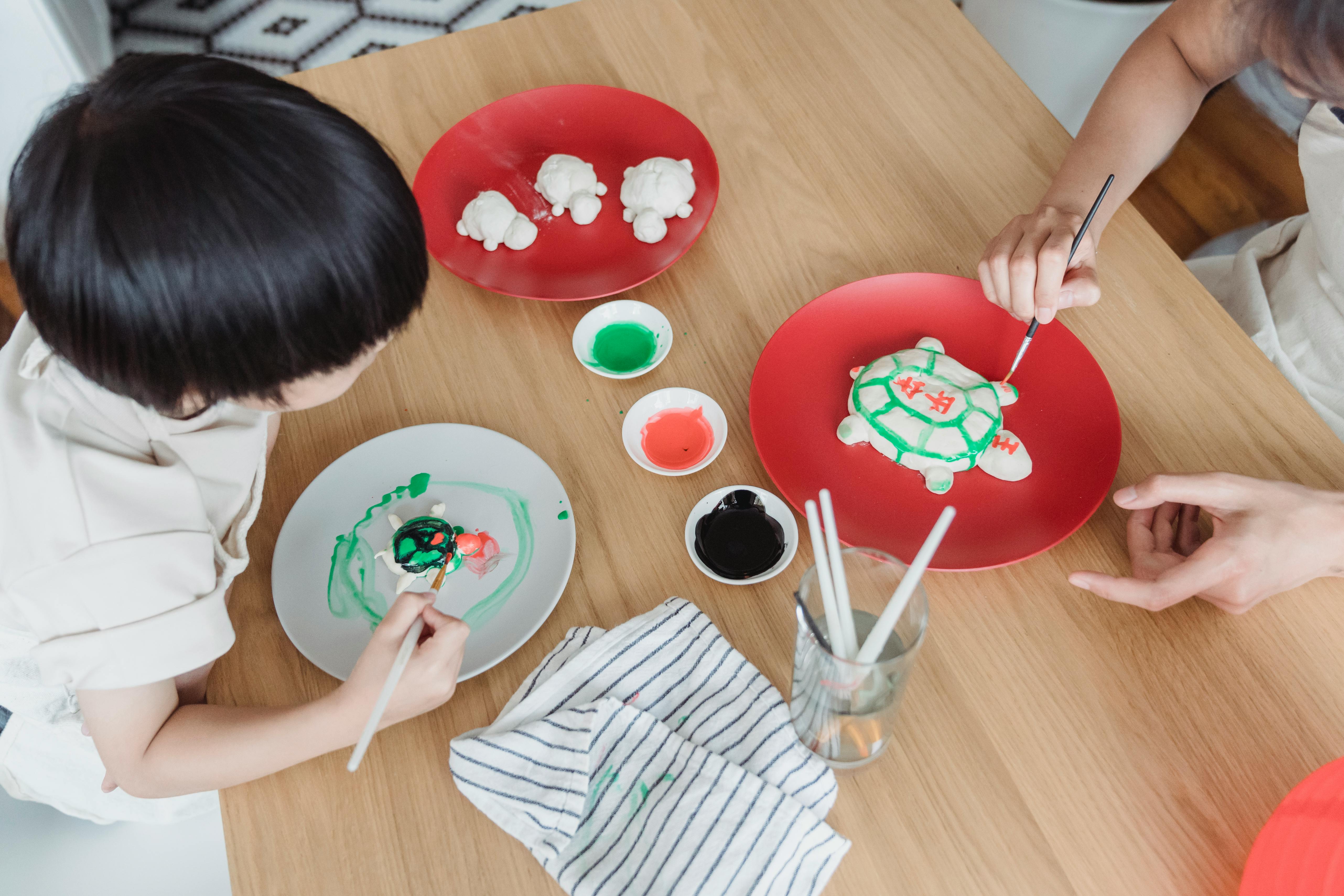 mother and son painting at the table