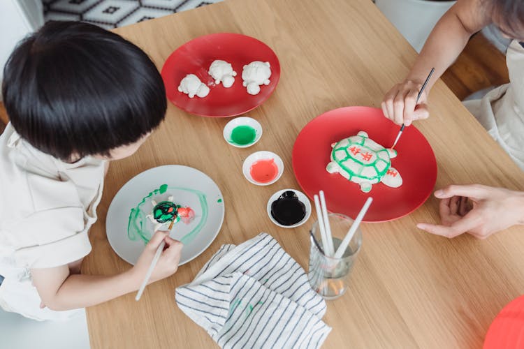 Mother And Son Painting At The Table