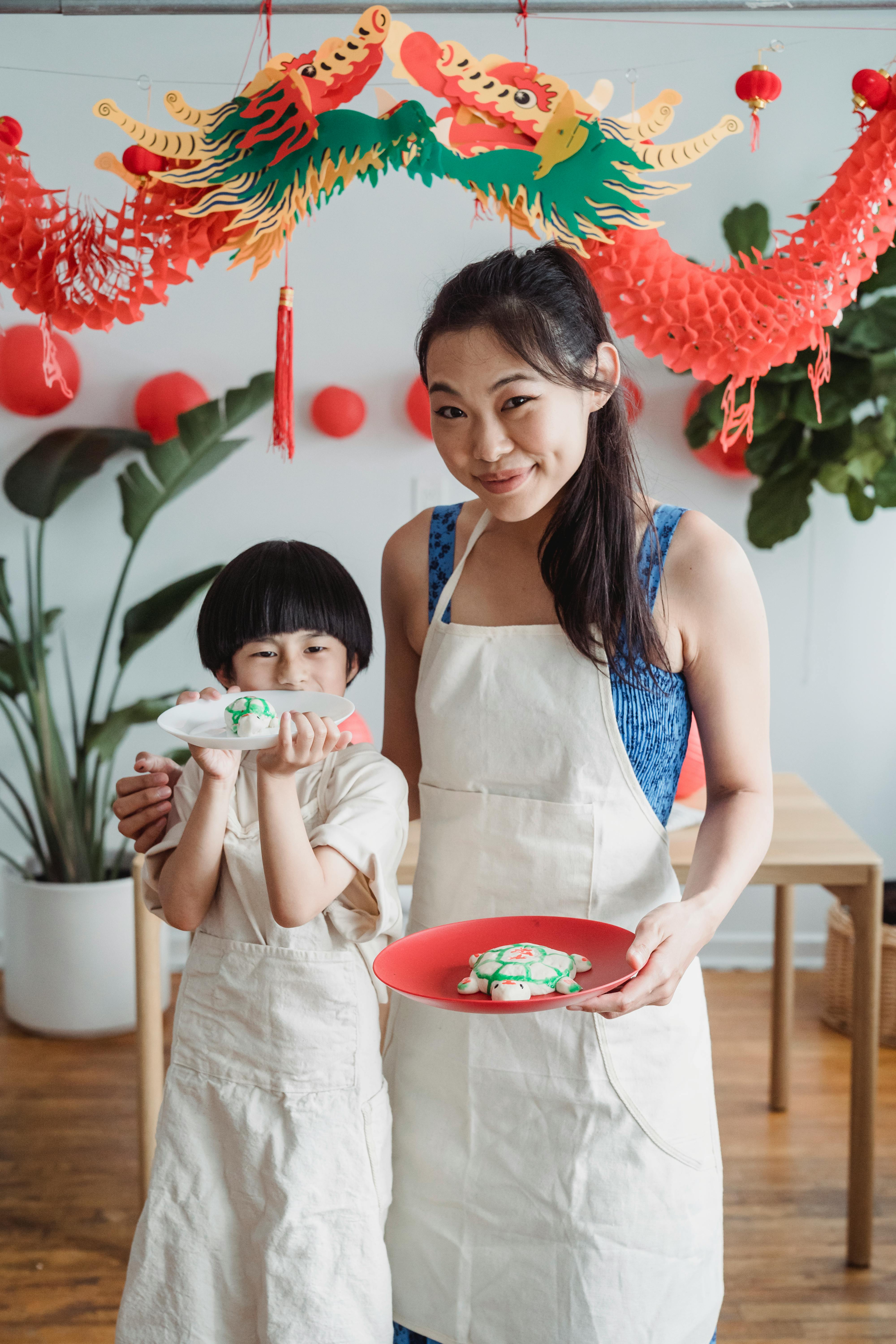 mother and son holding plates with snacks