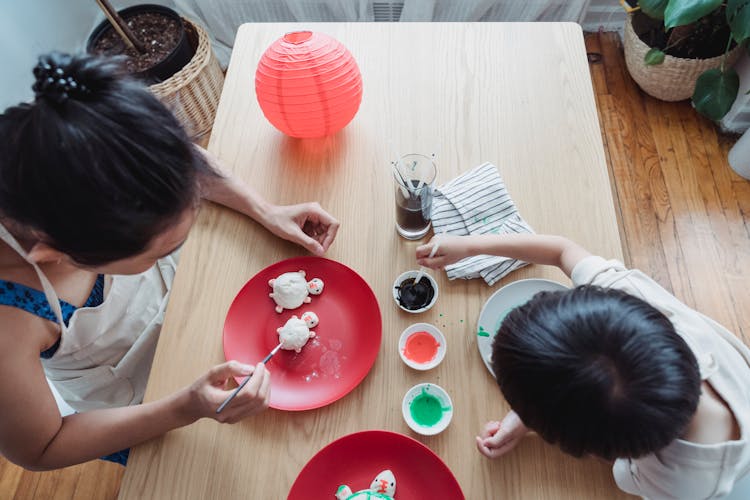 A Mother And Child Painting Turtle Shape Dough