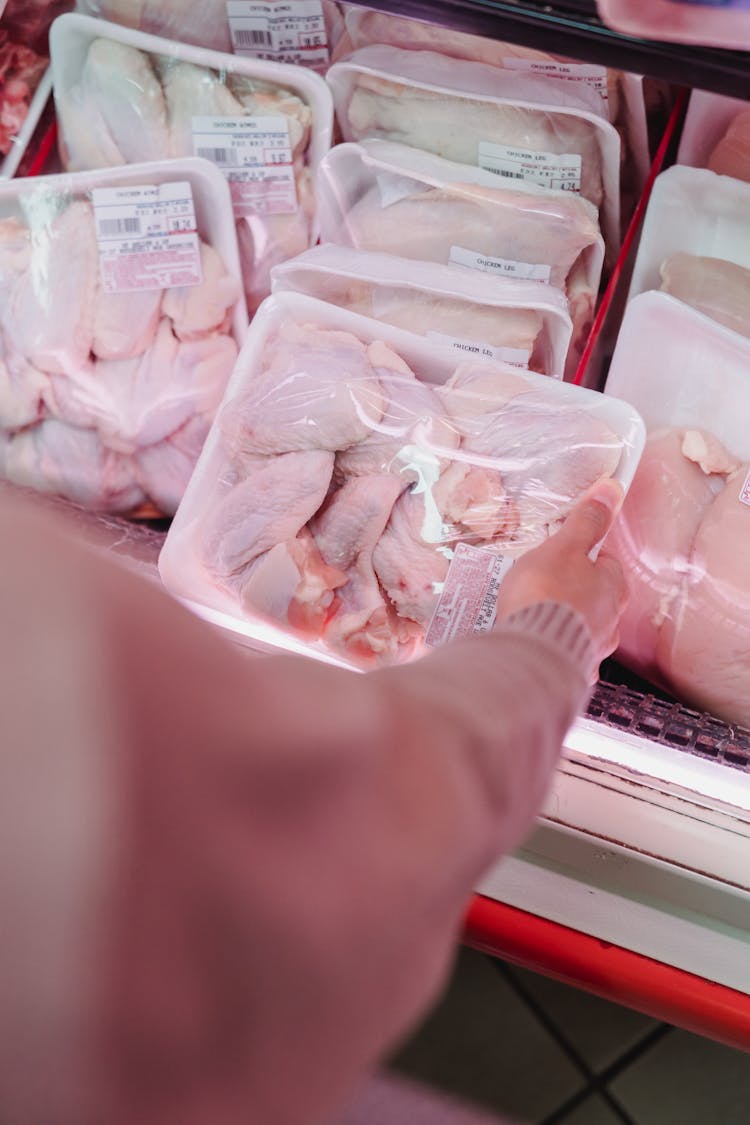 Woman Buying Meat In A Store