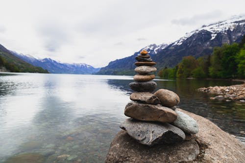 Brown and Gray Stone Stack Near Body of Water