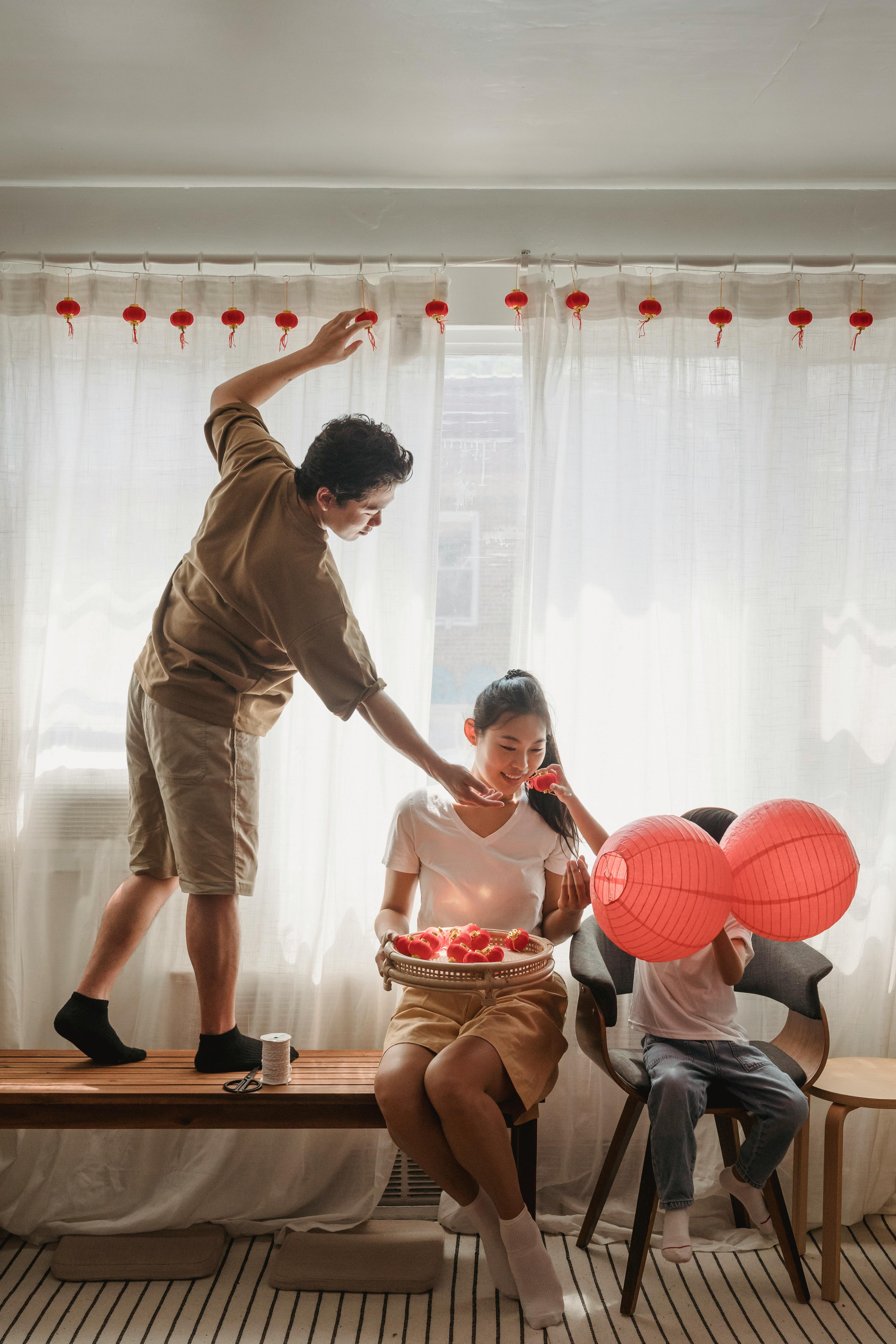 woman a man and a kid decorating their living room