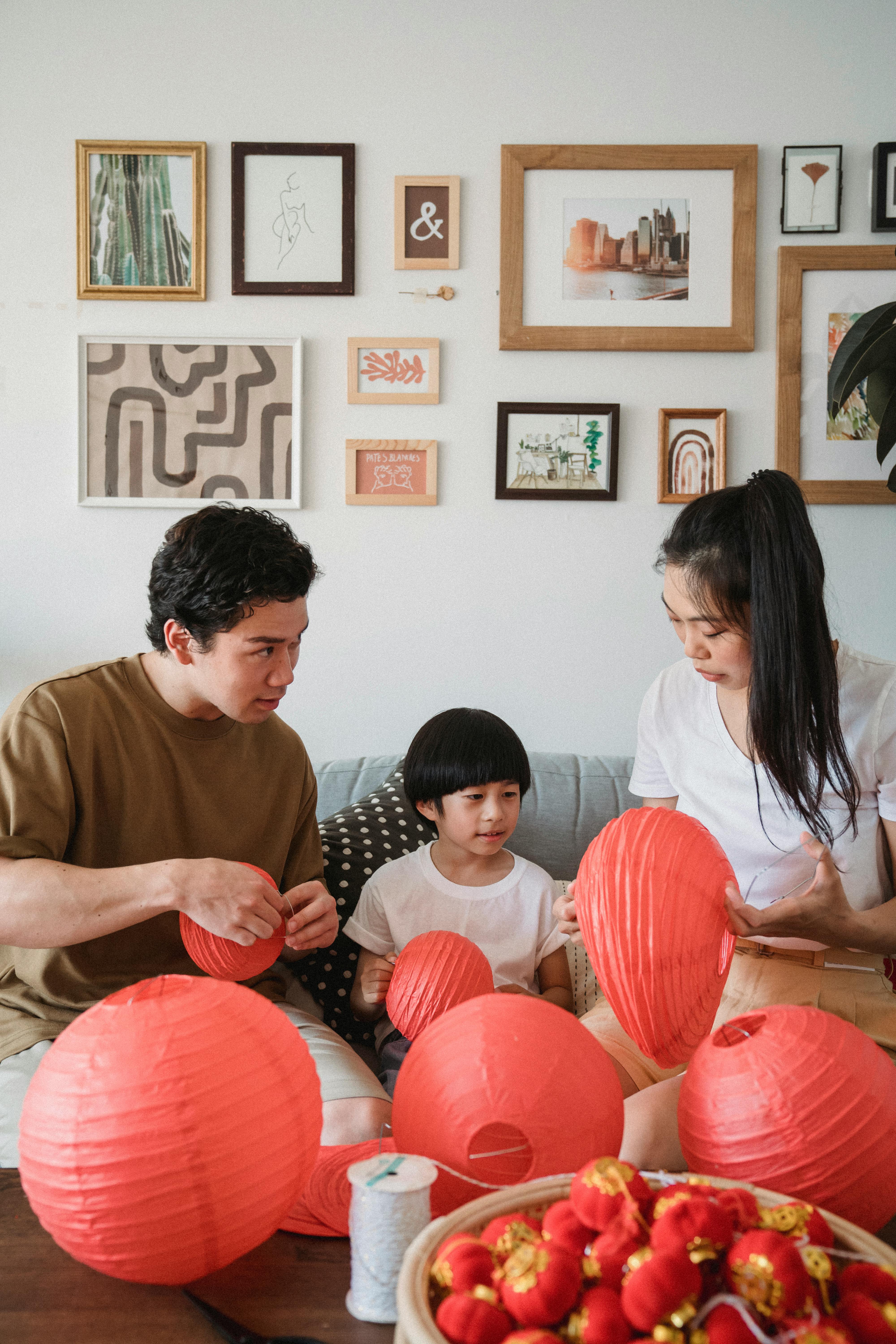 couple with a child preparing red lanterns