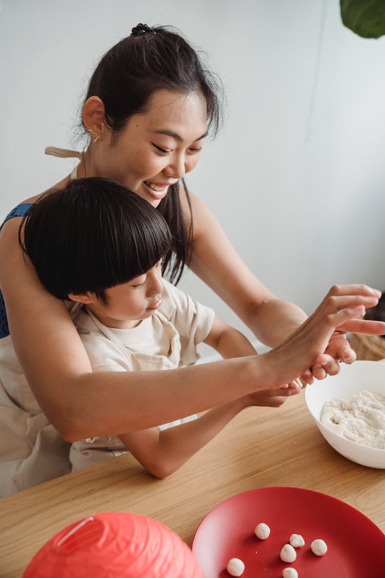 Smiling Mother Cooking With Son