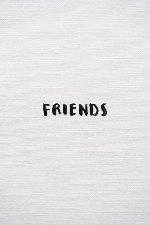 Free A minimalist art piece with the word 'FRIENDS' on a textured white background. Stock Photo