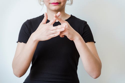 Woman in Black Top Making Hand Gestures