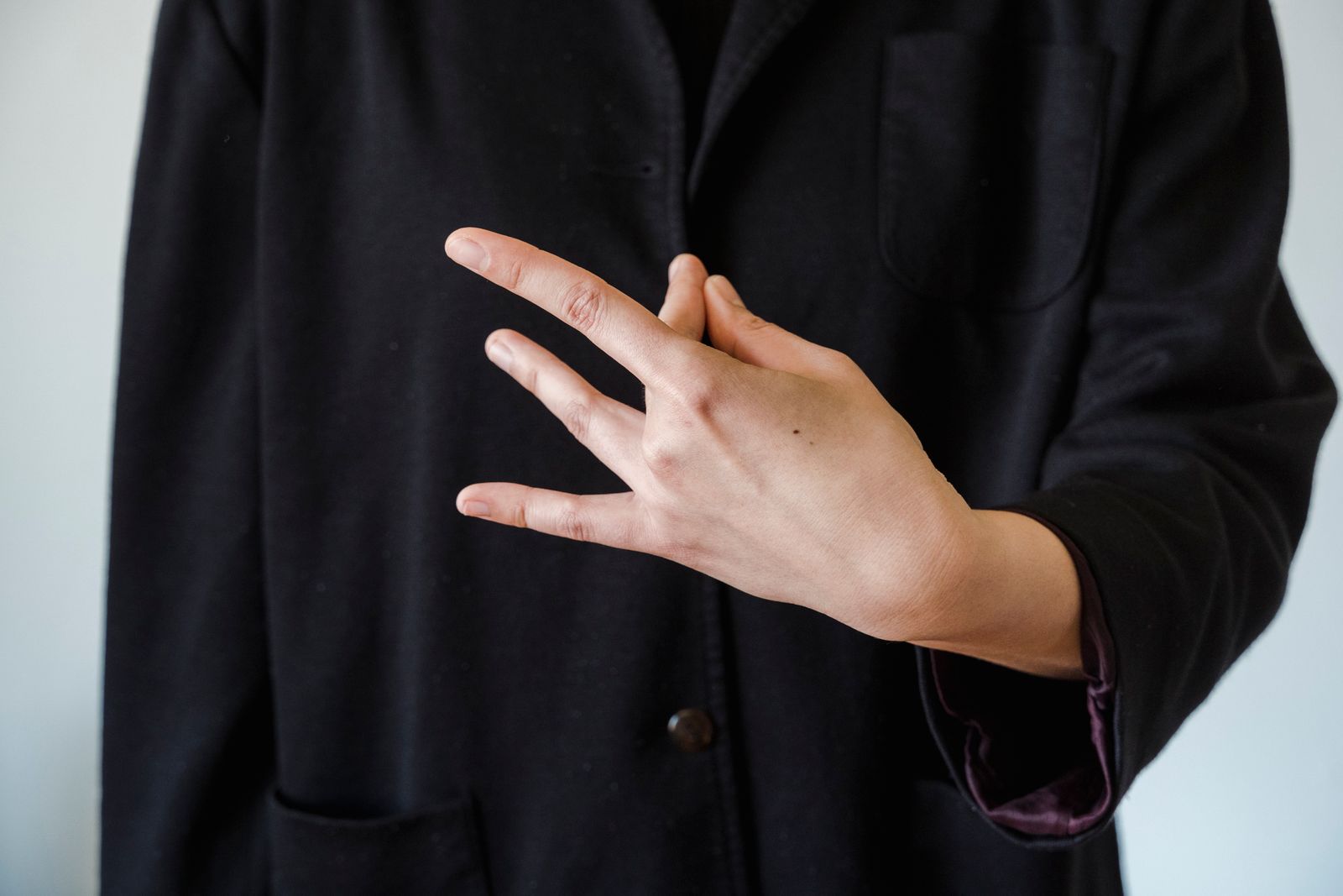 Close-up of hands forming a mudra hand gesture used in yoga and meditation practice