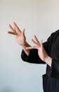 Person in Black Long Sleeve Shirt Doing Sign Language