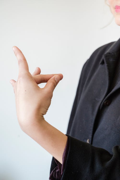 Woman in Black Button Up Shirt Doing Sign Language