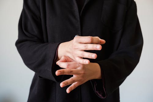 Hands of Person in Black Long Sleeve Shirt 