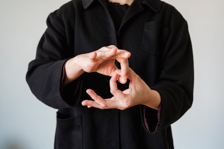 Person In Black Coat Gesturing