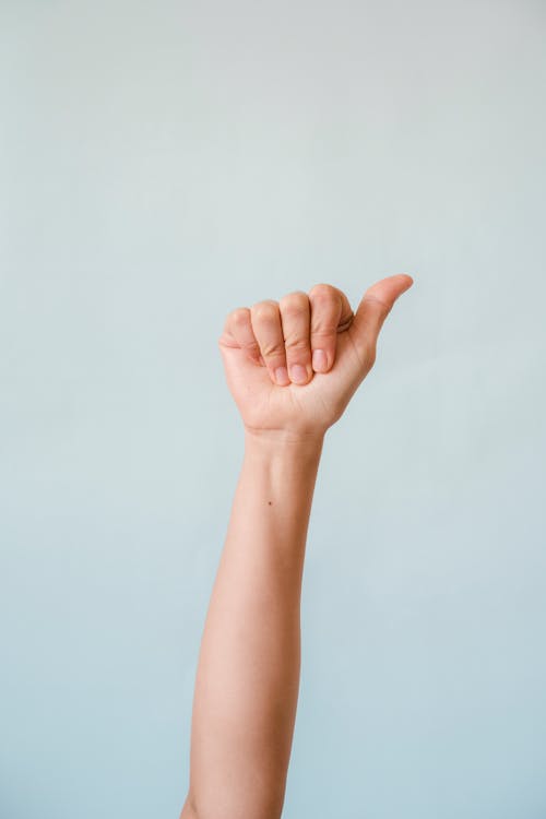 Free Persons Right Hand Doing a Thumbs Up Stock Photo