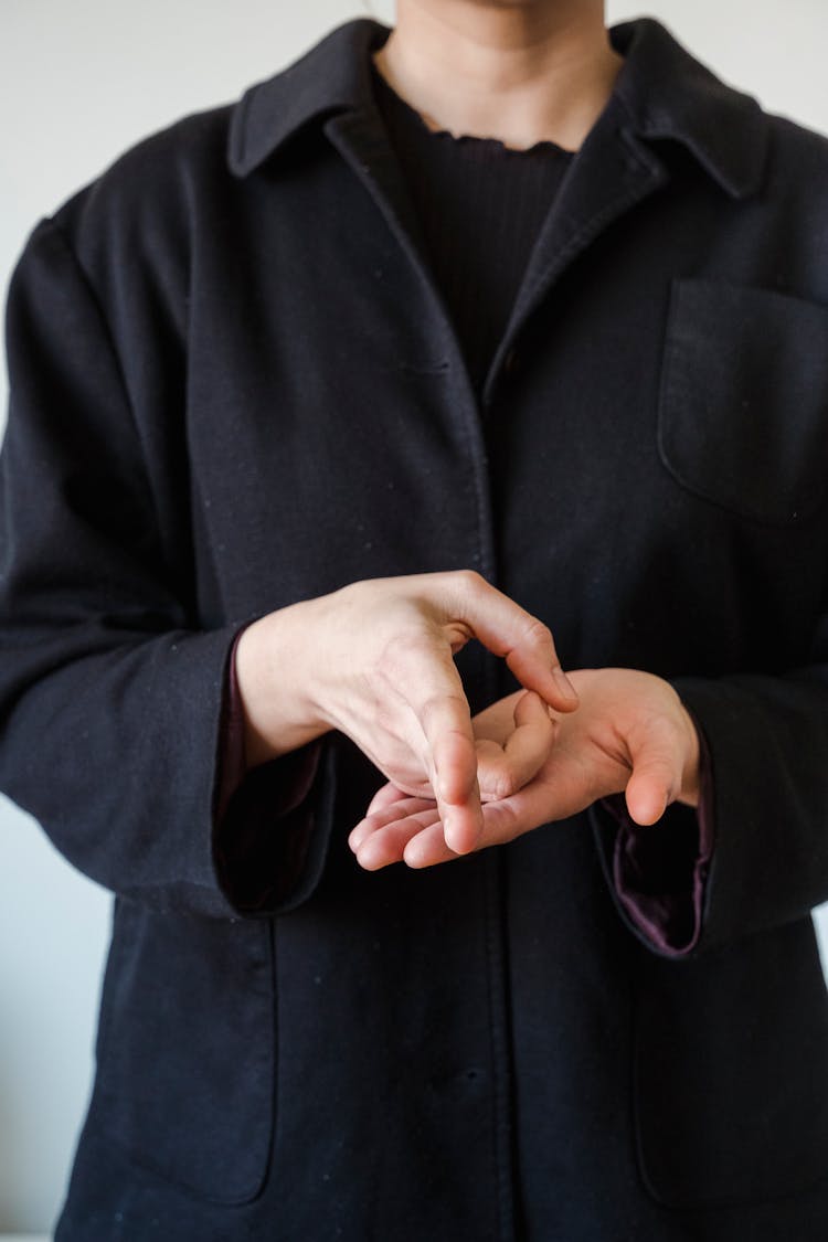 Person In Coat Using Sign Language