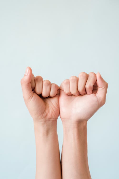 People Fists on Green Studio Background