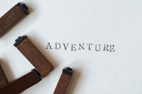 Free Adventure Stamped on White Paper Stock Photo