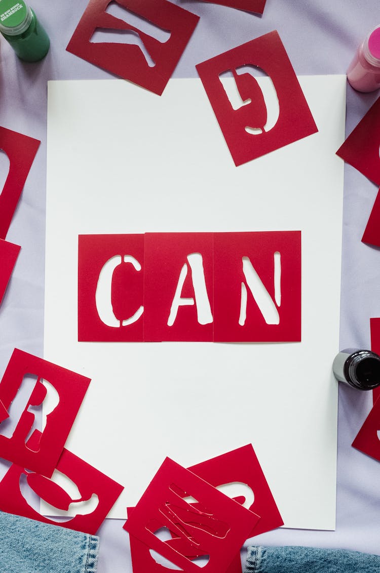 Red Stencil Text Tiles On A White Paper