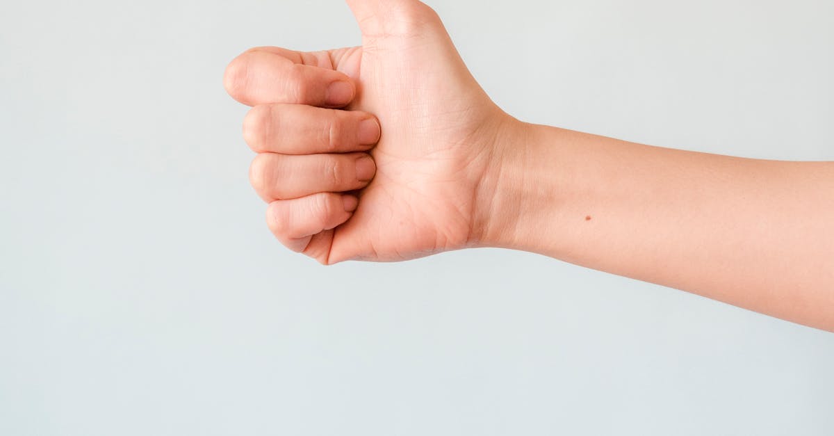 Photo by Kevin Malik A close-up view of a hand showing a thumbs up against a plain background.