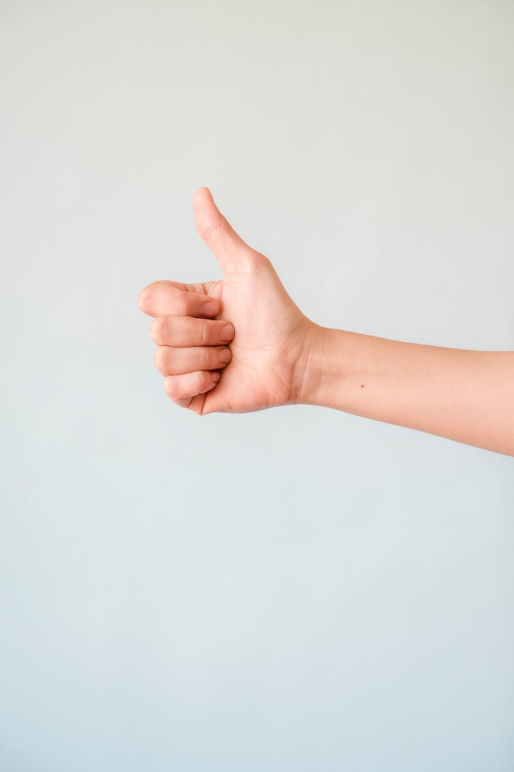 Person's Right Hand Doing Thumbs Up