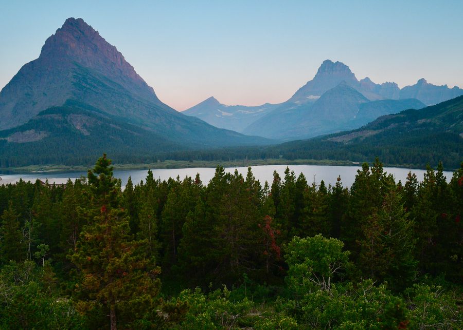 Mountains above a Glacier National Park lake, the scale that free Montana dating sites help you plan around