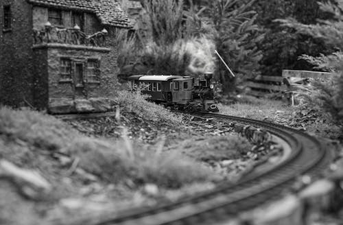 Grayscale Photo of Train in Rail Tracks