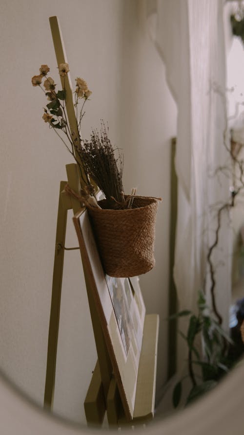 Free Easel with a Picture and a Flowers in a Pot Hung on It  Stock Photo