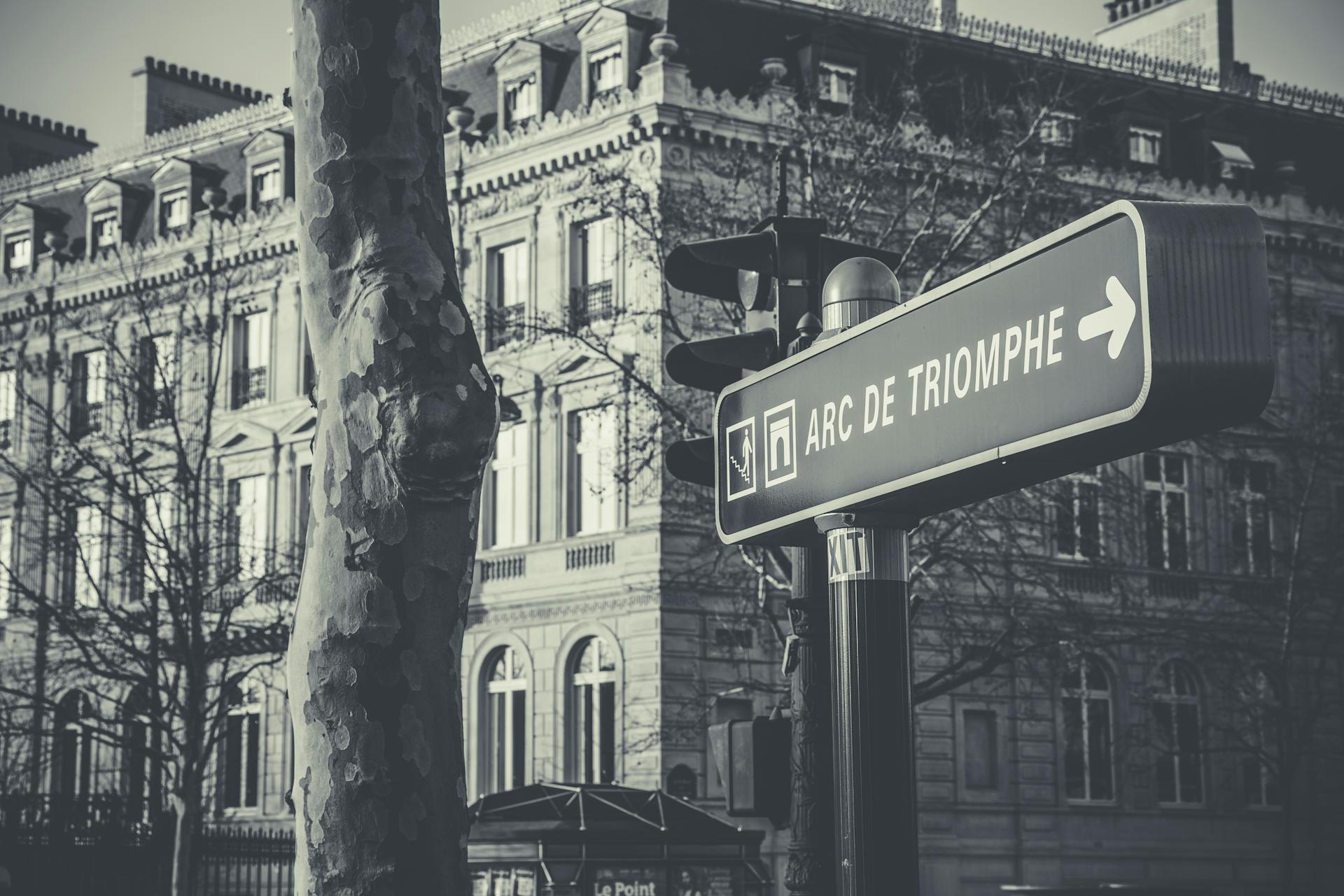 Grayscale Photo of Black and White Arc De Triomphe Street Sign