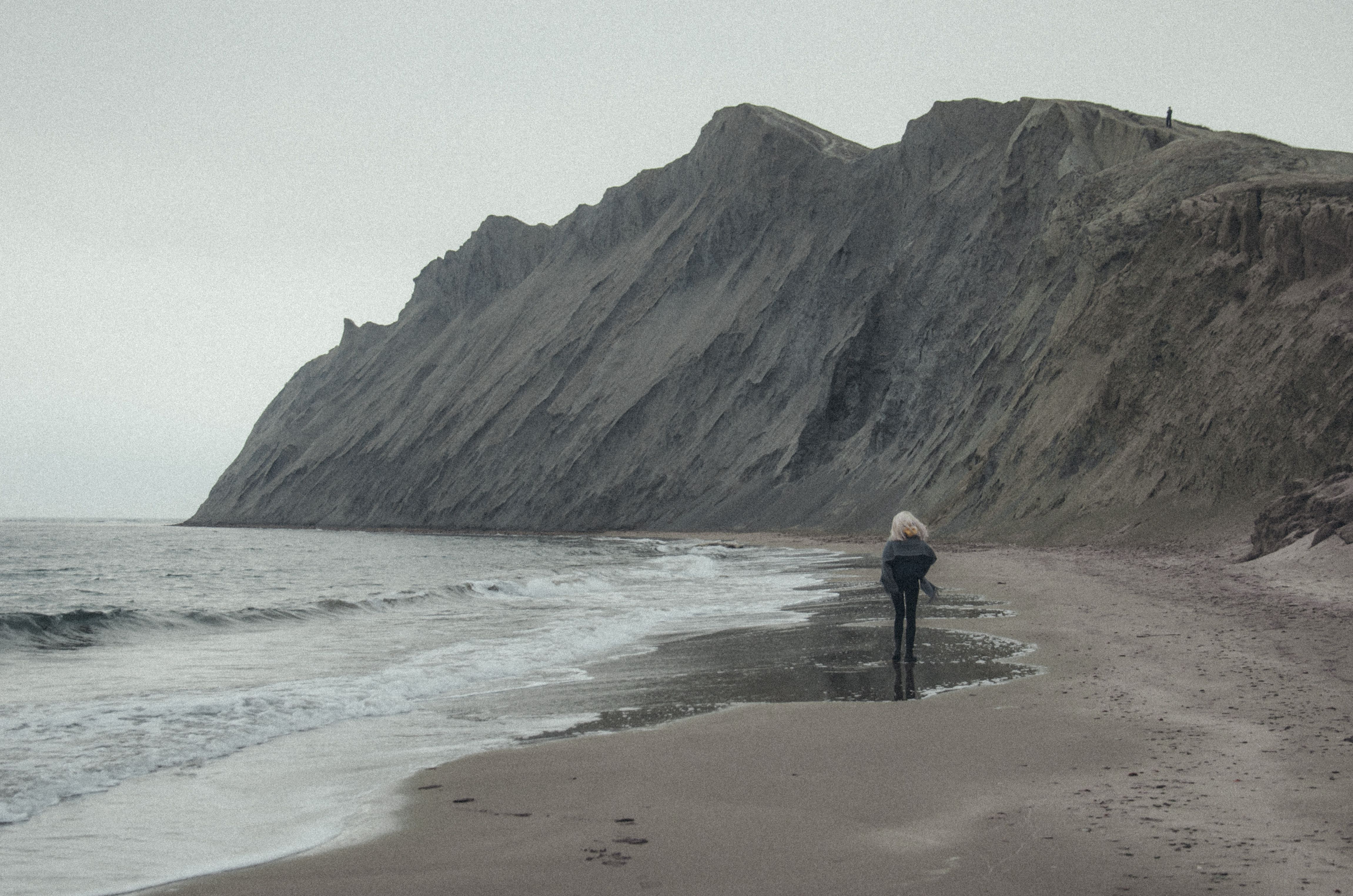 A Woman Walking on a Beach · Free Stock Photo