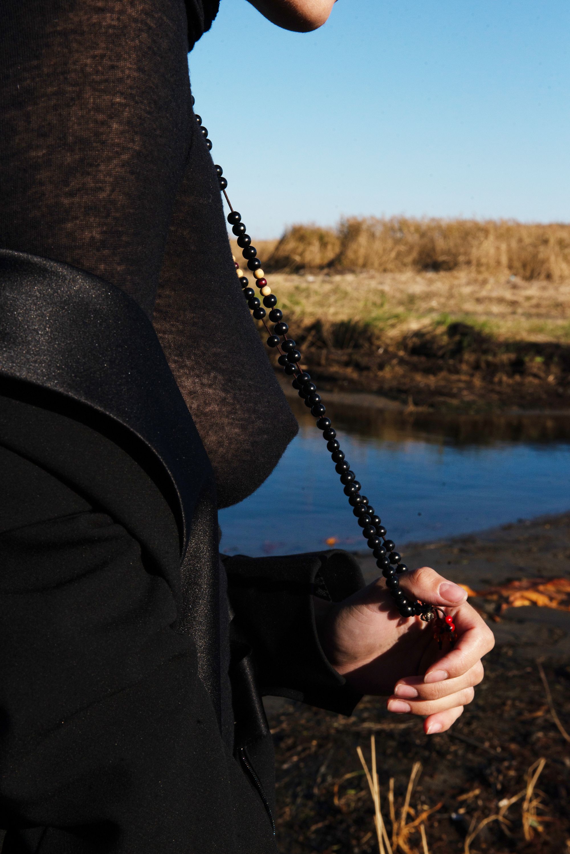 Person Holding Black Prayer Beads · Free Stock Photo