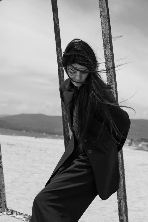 Free Stylish black and white portrait of a woman in a suit jacket outdoors. Stock Photo