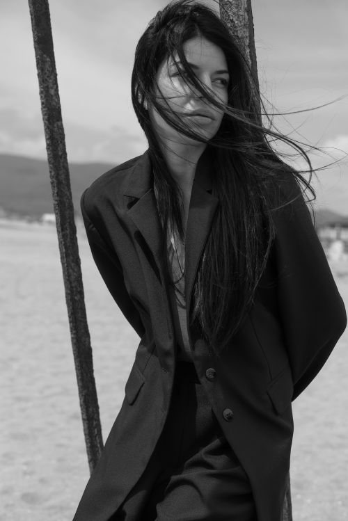 Free Striking black and white portrait of a woman in a blazer on a windy day. Stock Photo