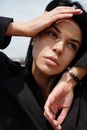 Woman in Black Coat Wearing Silver and Black Beaded Bracelet