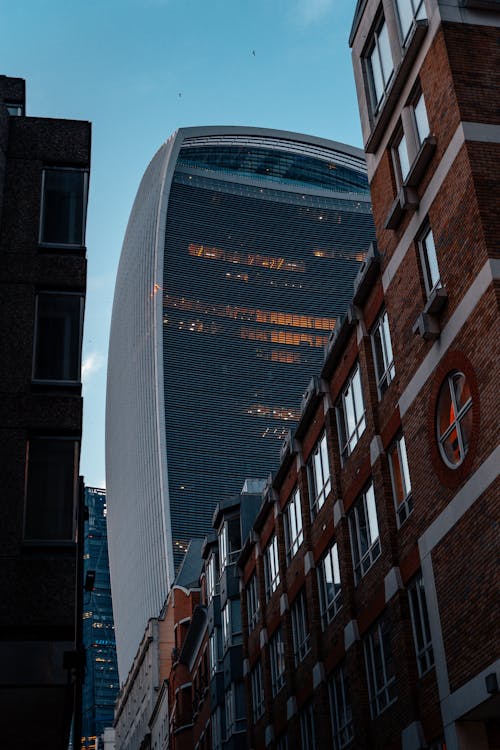 Brick Building With Glass Windows Near a High Rise Building