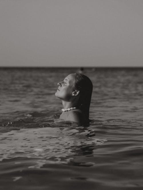 Grayscale Photo of a Woman in the Water