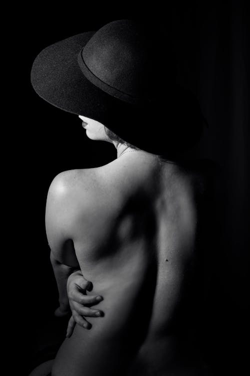 Topless Woman Wearing a Large Hat