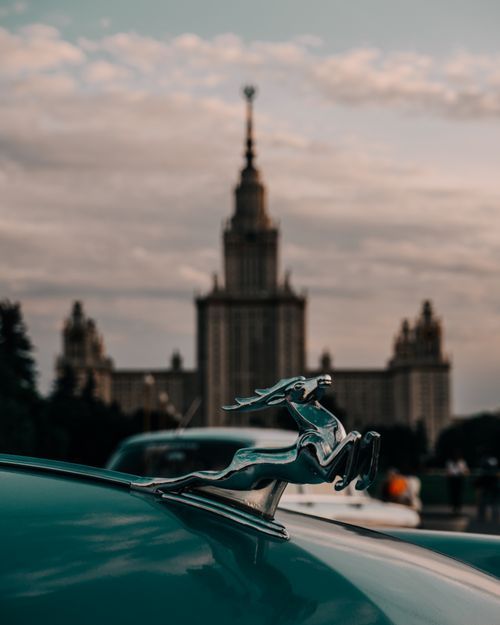 Free Vintage car emblem with Moscow State University in the background at sunset. Stock Photo