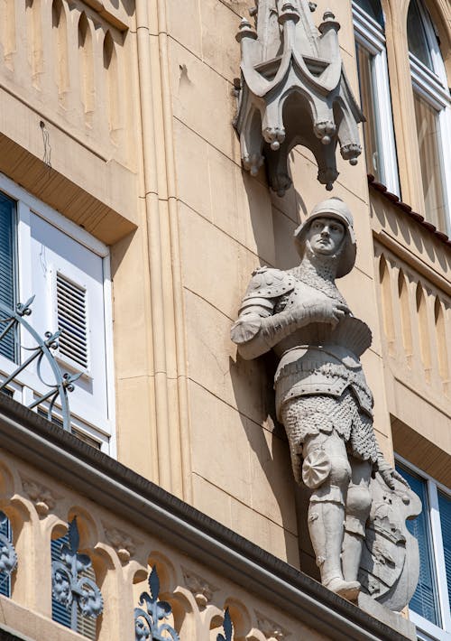 Gray Concrete Statue of Man on a Building