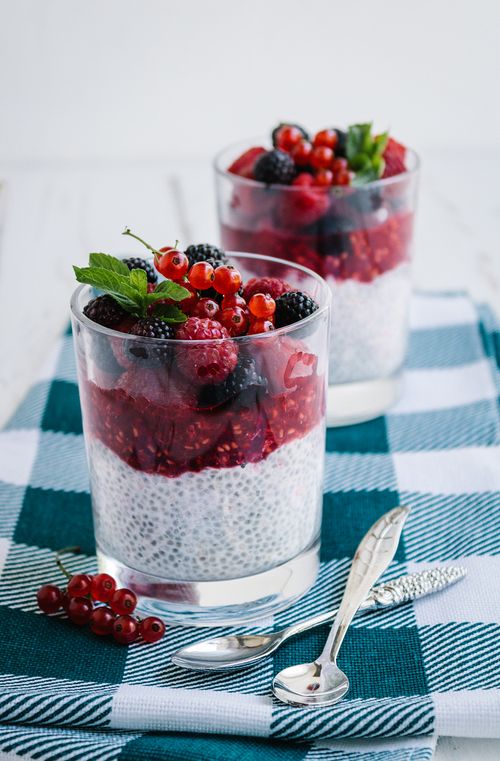 Free Delicious chia pudding topped with fresh berries on a checkered tablecloth. Stock Photo