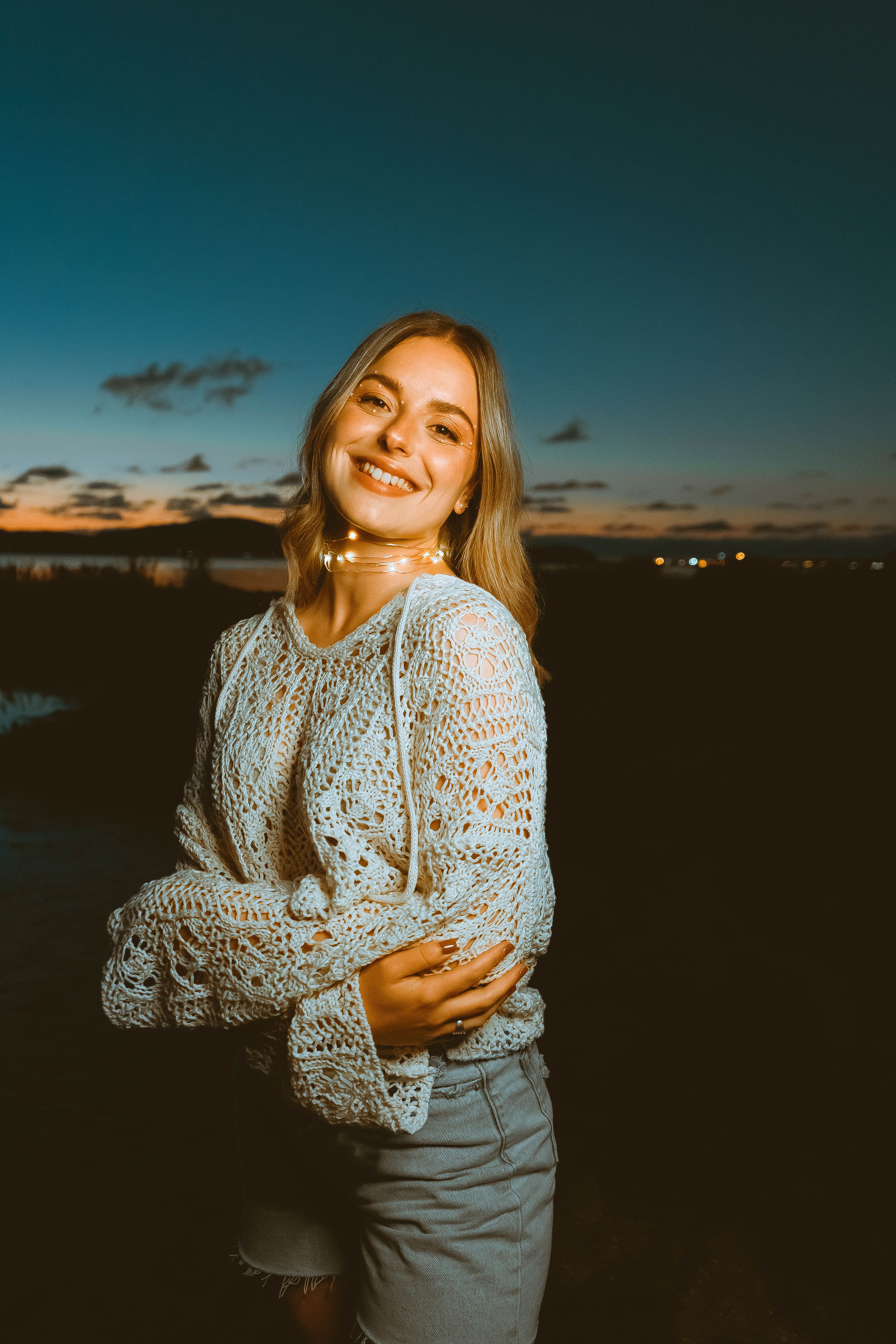 A Woman in White Knitted Sweater Smiling with Her Arms Crossed · Free ...