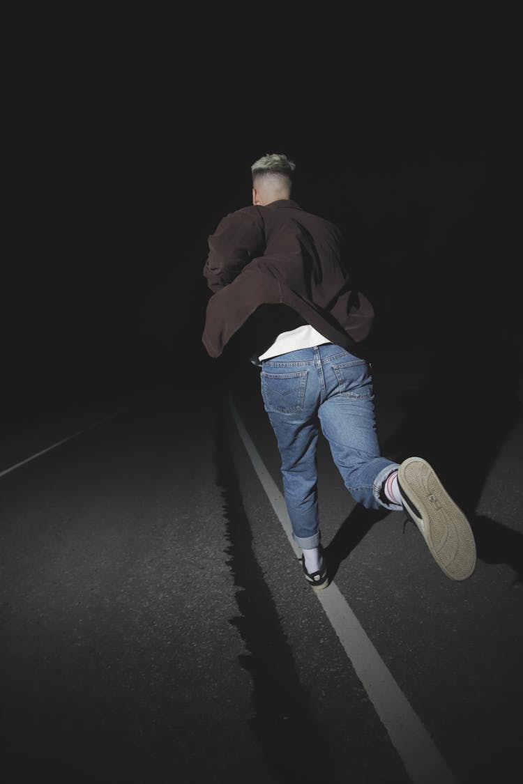 Man Running In The Road During Night Time