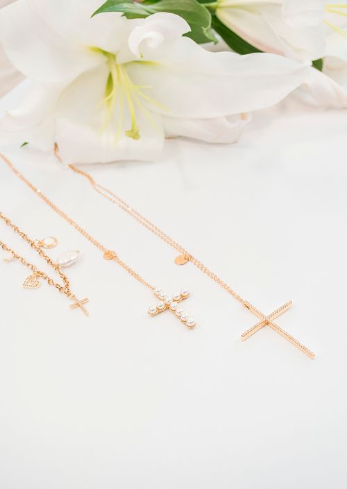 Free Beautiful arrangement of gold cross necklaces and white lilies on a soft background. Stock Photo