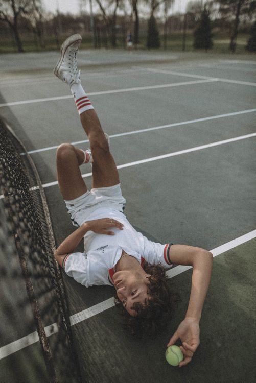Free Person Wearing Polo Shirt Lying on Tennis Court Stock Photo