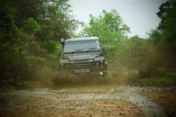 Black Suv on Dirt Road Near Green Trees
